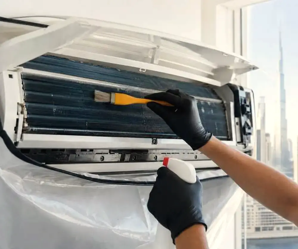 Technician cleaning the indoor unit of a split AC
